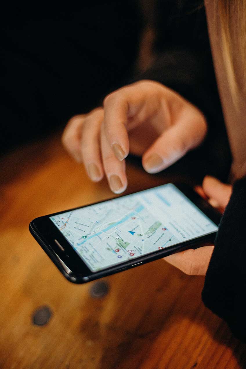 person searching on google maps using mobile