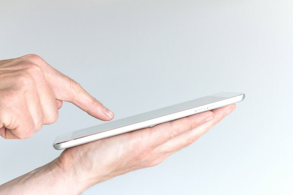 Fingertip touching a mobile device’s screen