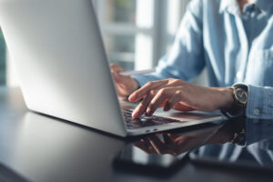 person typing on a laptop
