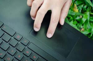 index finger hovering over a trackpad