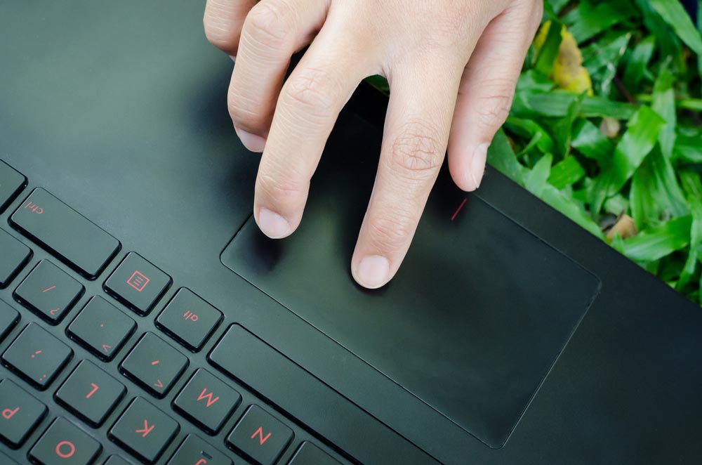 index finger hovering over a trackpad